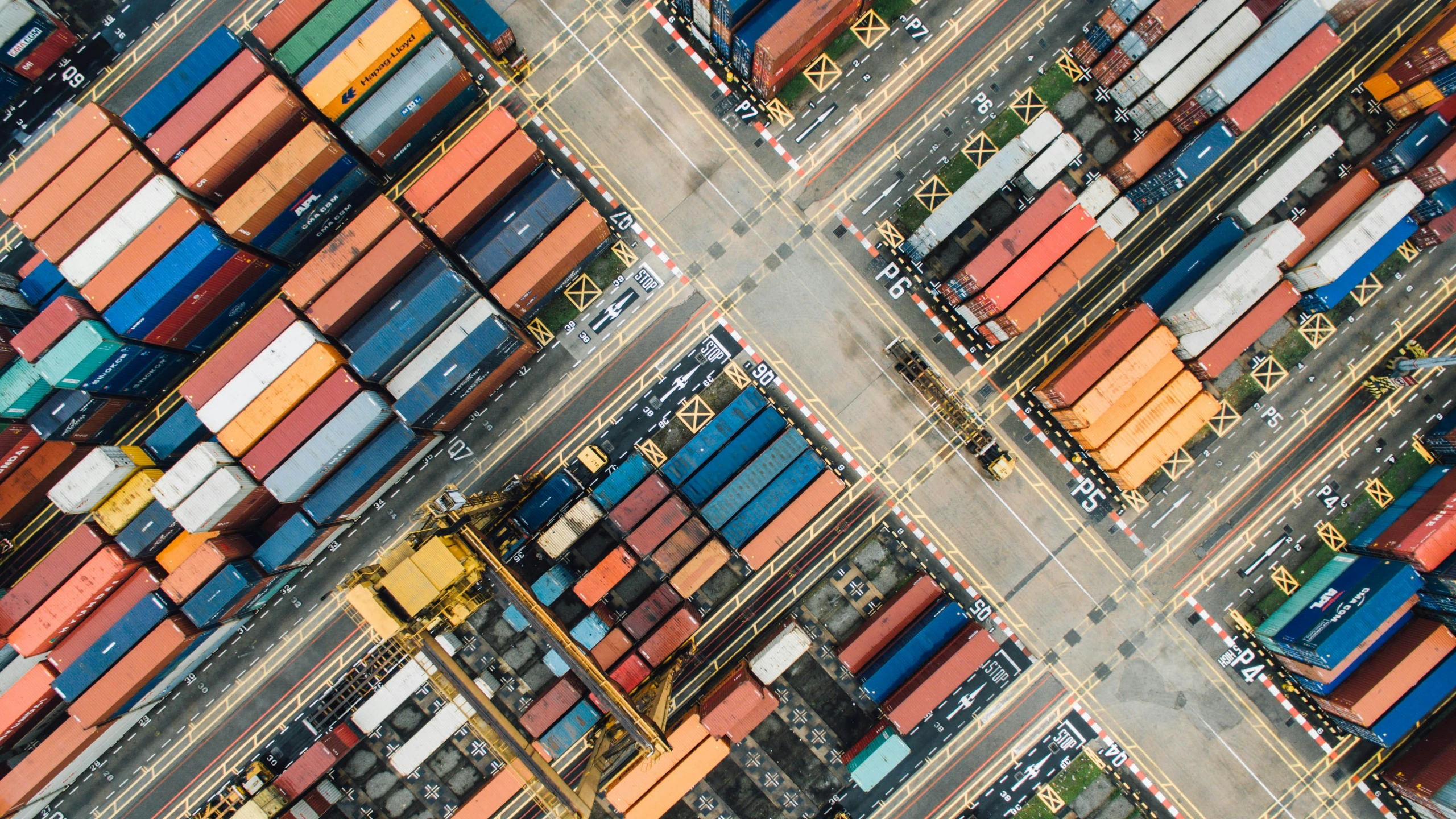 Aerial photo of shipping containers at a busy port.