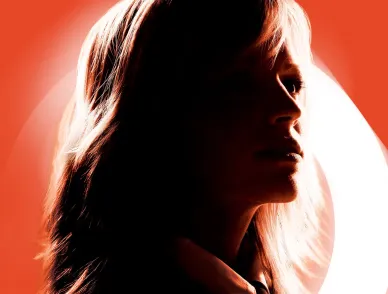 Silhouetted profile of a person facing right, backlit by warm orange and white lighting against an ochre background.